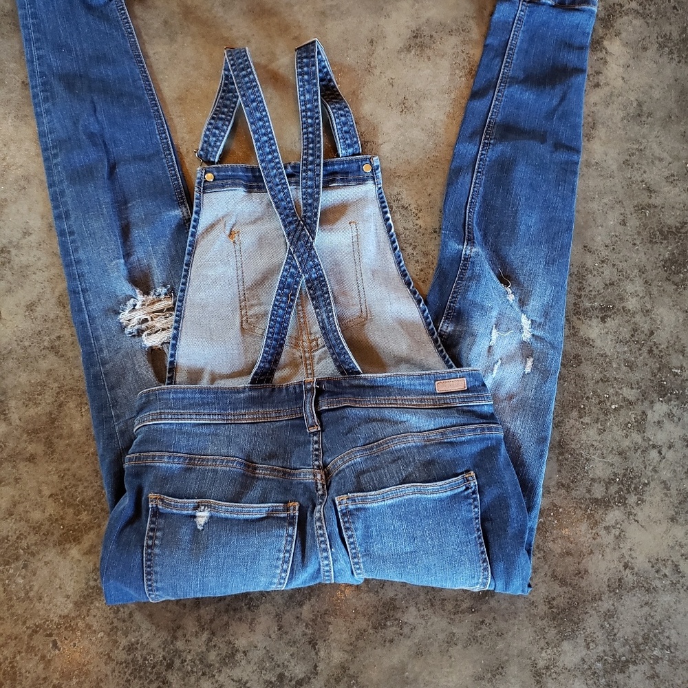 Distressed denim overalls